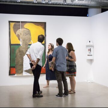 A group of people in a gallery. 