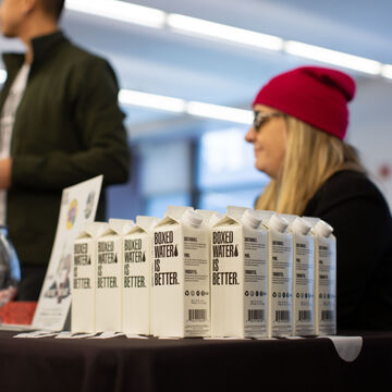 Boxed water being given out to students at the neiman center