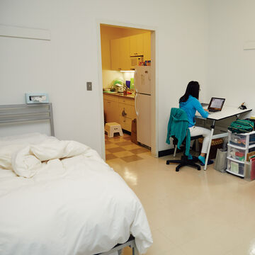 A student works at their desk in the dorms