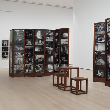 An installation at MOMA consisting of many black and white photos.