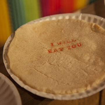 A pie with the words “I will eat you” on the top.