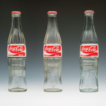 Three Coca-Cola cans