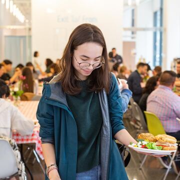 A student adding food to their plate at the neiman center