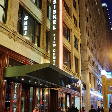 The facade of the Gene Siskel Film Center at night.