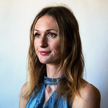 A headshot of Abigail Brudek wearing a blue top.