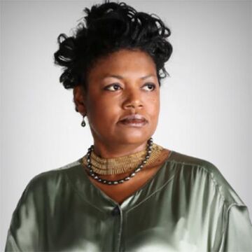A headshot of Clemenstien Love wearing a green top.
