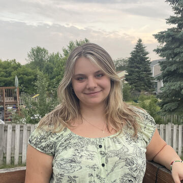 A portrait of a person smiling outdoors