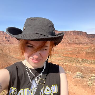 A selfie of a person standing outdoors 