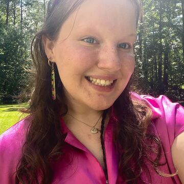 A selfie of a person smiling outdoors