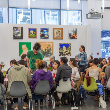 A large group of students sitting at a table together. 