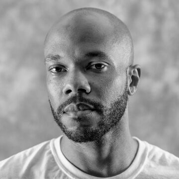 A black and white portrait of a designer