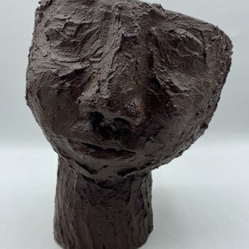 A ceramic sculpture of a head 
