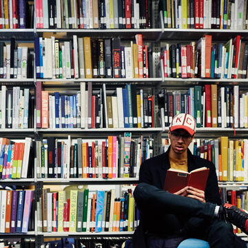 A person sitting and reading inside a library