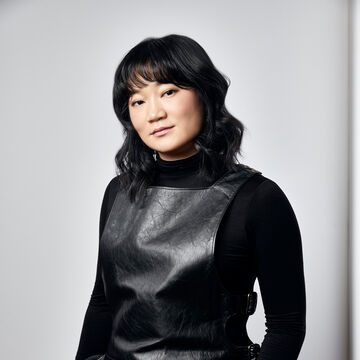 Image of artist in black outfit in gray background