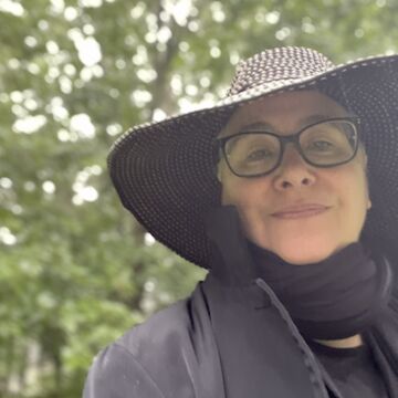 Selfie of a white woman with a tree in the background