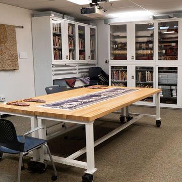 Resource space with a table, chairs, and shelving units