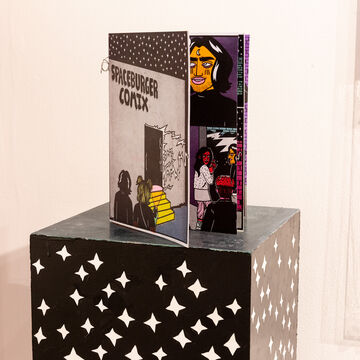 Comic book by Brooke Lord on display in a gallery space
