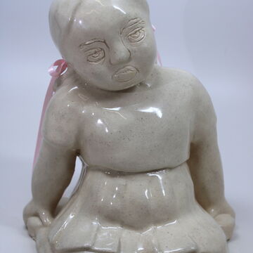 Ceramic piece by Sophia Muys of a small child sitting on their knees