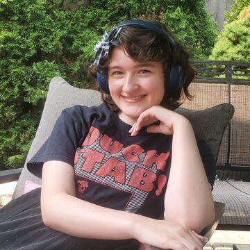 Portrait photograph of Clare Haffner reclining in a patio chair