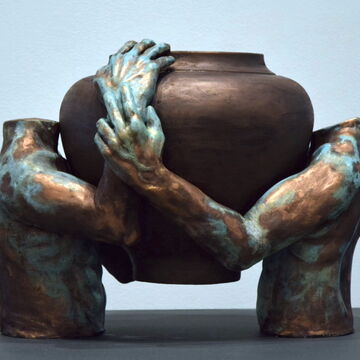 Ceramic piece by Henry Tyson of two torsos embracing a basin
