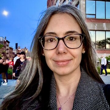 Selfie of Lauren Ball, a fair-skinned brunette woman wearing glasses.