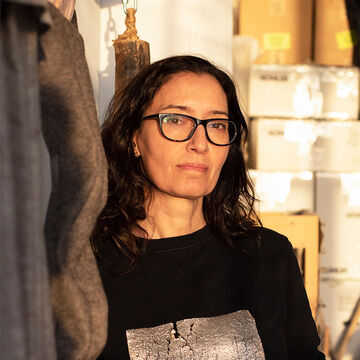 Portrait of a fair-skinned adult woman wearing glasses.