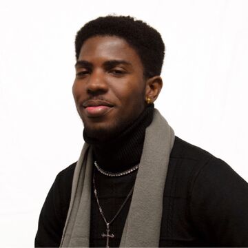 Headshot of Jeffrey Ohuaregbe, an adult dark-skinned person with dark, short, coily hair.
