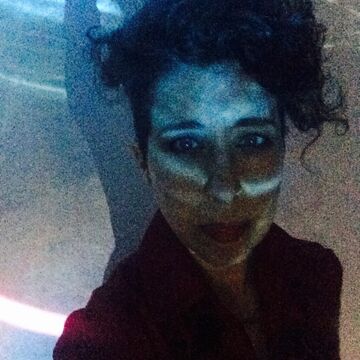 Selfie of Valerie Xanos, an adult person with a fair skin tone and short curly hair.