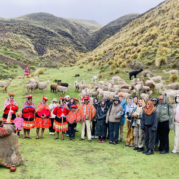 A group of students poses in Peru with local people