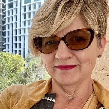 Selfie of Margaret Koreman, an adult with a fair skin tone, blonde pixie cut and sunglasses. 