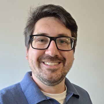 Selfie of Tim Wiggins, an adult person with fair skin, glasses, and short brown hair.