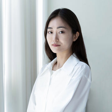 Headshot of Christina Lee, an adult Asian person with fair skin and long black hair.
