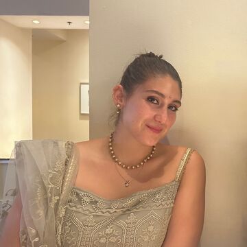 Portrait of Fiona Brackley, an adult with a medium-fair skin tone and brown hair wearing a sari.