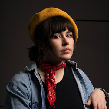 Headshot of C Armstrong, an adult person with a medium-fair skin tone and short dark hair. 