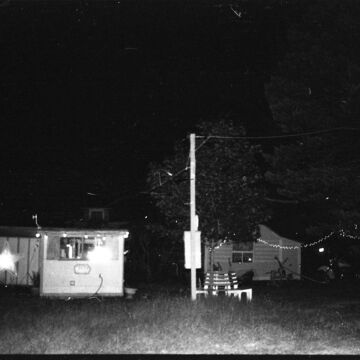 A black and white image of buildings at night.