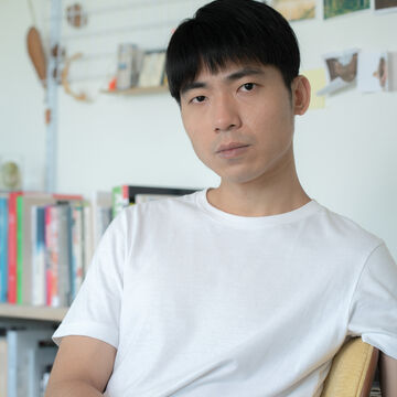 Headshot of Huang I-Chieh, an adult Taiwanese person with a medium-fair skin tone and short straight black hair. 