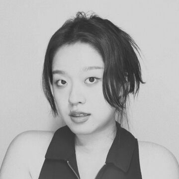 Black and white headshot of Haejung Lee, an adult Korean person with a fair skin tone and black hair. 