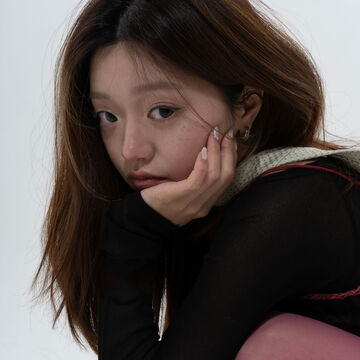 Portrait of Helen Sungmin Lee, an adult Asian person with a fair skin tone and straight brown hair. 