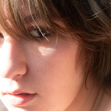 Portrait of Stefania Andreev, an adult person with a fair skin tone and chin-length brown hair.