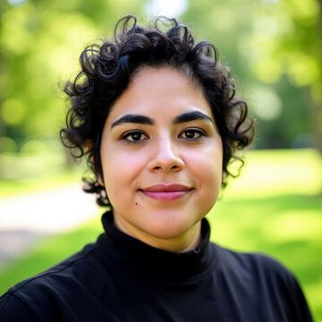 SAIC faculty Libia Bianibi, a person with medium-light skin tone and dark hair, standing outside.