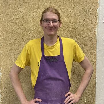 Headshot of Felix Horan, an adult person with blonde hair, a fair skin tone, and glasses. 