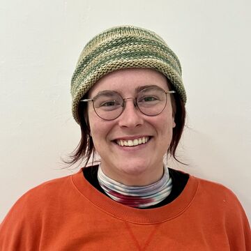 Headshot of Rachel "Ranch" Ward, an adul tperson with a fair skin tone, glasses, and chin-lenght dark hair. 