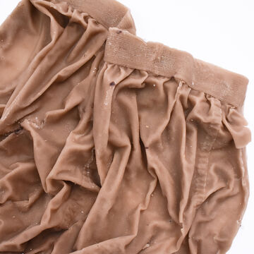 A beige cloth garment with wrinkles.