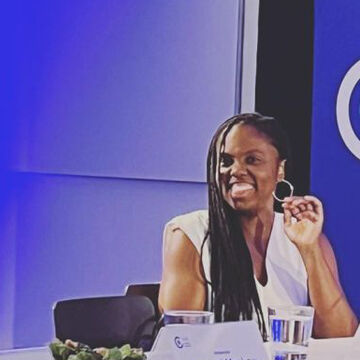 Asha Iman Veal, a Black woman, seated and smiling. 