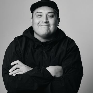 Black and white headshot of Hector Silva, an adult person with a medium-fair skin tone. 