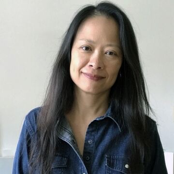 Portrait of Ann Chen, an adult Asian person with a medium-fair skin tone and long dark hair. 