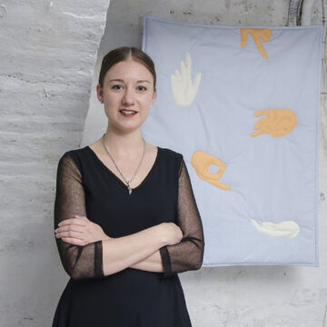 Headshot of Christalena Hughmanick, an adult person with a fair skin tone and pulled back hair. 