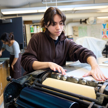 A student working in the Visual Communication Design letterpress studio.