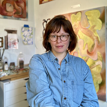 Kaylee Wyatt, an adult person with a fair skin tone, medium-short hair, and glasses.  