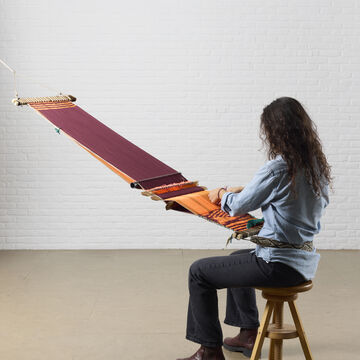 Artist Maria Jose Murillo is backstrap weaving.